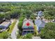 Aerial view of a charming blue two-story home surrounded by mature trees and lush greenery at 6022 S Elkins Ave, Tampa, FL 33611