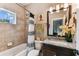 Bathroom featuring a granite vanity top, a tub, and a tiled shower with curtains at 6022 S Elkins Ave, Tampa, FL 33611