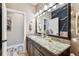 Stylish bathroom featuring granite counters, modern lighting, and a decorative mirror at 6022 S Elkins Ave, Tampa, FL 33611