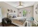Cozy bedroom with wooden floors, neutral paint, and a bright window view at 6022 S Elkins Ave, Tampa, FL 33611