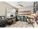 Eclectic bedroom space with hardwood style floors, fan, desk, and collection display at 6022 S Elkins Ave, Tampa, FL 33611