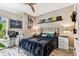 Cozy bedroom features hardwood floors, ceiling fan, and comfortable decor at 6022 S Elkins Ave, Tampa, FL 33611