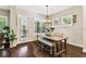 Bright dining room with plantation shutters, modern lighting, and wood-look flooring at 6022 S Elkins Ave, Tampa, FL 33611