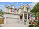 Charming two-story home features red shutters, a covered porch, and an attached two car garage at 6022 S Elkins Ave, Tampa, FL 33611