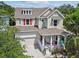 Beautiful two-story home with a cozy front porch, a two car garage and well manicured lawn at 6022 S Elkins Ave, Tampa, FL 33611