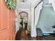 Welcoming foyer featuring hardwood floors, an arched doorway, and an adjacent exercise area at 6022 S Elkins Ave, Tampa, FL 33611
