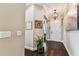 Welcoming foyer featuring dark wood floors, neutral paint, and a decorative chandelier at 6022 S Elkins Ave, Tampa, FL 33611