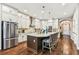 Well-equipped kitchen with oversized island, white cabinetry, and stainless steel appliances at 6022 S Elkins Ave, Tampa, FL 33611