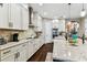 Bright kitchen with granite countertops, stainless steel appliances, and white cabinets at 6022 S Elkins Ave, Tampa, FL 33611