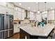 Beautiful kitchen with stainless steel refrigerator, white cabinets, and a large island at 6022 S Elkins Ave, Tampa, FL 33611