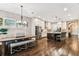 Open-concept kitchen featuring stainless steel appliances, a large island, and hardwood floors at 6022 S Elkins Ave, Tampa, FL 33611