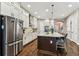 Spacious kitchen with stainless steel refrigerator and a large island with seating at 6022 S Elkins Ave, Tampa, FL 33611