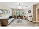 Cozy living room with wood look tile flooring, lots of natural light and stylish contemporary decor at 6022 S Elkins Ave, Tampa, FL 33611