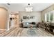 Living room with wood-look floors, modern furniture, stylish decor and natural lighting at 6022 S Elkins Ave, Tampa, FL 33611