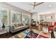 Cozy living room with hardwood floors, multiple windows and comfortable furnishings at 6022 S Elkins Ave, Tampa, FL 33611