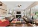 Inviting living room with wood floors, neutral walls, comfortable sofas and a colorful area rug at 6022 S Elkins Ave, Tampa, FL 33611