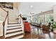 Bright living room with hardwood floors, fireplace and multiple windows with plantation shutters at 6022 S Elkins Ave, Tampa, FL 33611
