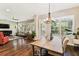 Inviting space combining living and dining areas with wood floors and shuttered windows at 6022 S Elkins Ave, Tampa, FL 33611