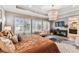 Bright main bedroom with plush furniture, elegant chandelier, and an ensuite bathroom access at 6022 S Elkins Ave, Tampa, FL 33611