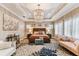 Beautiful main bedroom featuring a decorative chandelier, tray ceiling and natural light at 6022 S Elkins Ave, Tampa, FL 33611