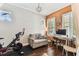 Home office area featuring an exercise bike, neutral paint, white blinds, and natural light at 6022 S Elkins Ave, Tampa, FL 33611