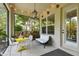 Enclosed patio with outdoor seating and views of the serene backyard at 6022 S Elkins Ave, Tampa, FL 33611