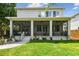 Relaxing outdoor screened in porch with comfortable seating and access to the lush green backyard at 6022 S Elkins Ave, Tampa, FL 33611