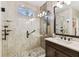 Modern shower featuring beautiful tile work, built-in shelves, and sleek fixtures at 6022 S Elkins Ave, Tampa, FL 33611