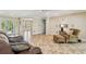 Spacious living area with tile flooring, sliding doors to the outside, and neutral decor for easy personalization at 607 Grovewood Ln, Largo, FL 33770