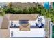 An aerial view features a building's roof, patio furniture, and a glimpse of the pool at 620 Bayway Blvd # 1, Clearwater, FL 33767