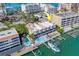 Aerial view of condo with a pool, docks, and boat slips on the waterfront at 620 Bayway Blvd # 1, Clearwater, FL 33767
