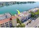 Aerial view shows a waterfront condo with boat docks along a scenic coastline at 620 Bayway Blvd # 1, Clearwater, FL 33767