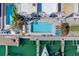 Aerial view showcases pool, docks, and boats adjacent to a waterfront condo building at 620 Bayway Blvd # 1, Clearwater, FL 33767