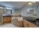 Luxurious bathroom with dual sinks, separate tub, walk in shower, and tile floors at 620 Bayway Blvd # 1, Clearwater, FL 33767