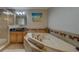 Bathroom featuring a bathtub, walk-in shower, tiled floors, and a unique sink at 620 Bayway Blvd # 1, Clearwater, FL 33767