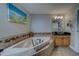 Corner view of a large soaking tub with jets, surrounded with tile and decorative accents at 620 Bayway Blvd # 1, Clearwater, FL 33767