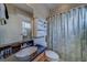 Bathroom with wooden vanity, dark countertop, and shower with tropical-themed curtain at 620 Bayway Blvd # 1, Clearwater, FL 33767