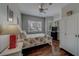 Bedroom with hardwood floors, ceiling fan, bright windows and a large bed at 620 Bayway Blvd # 1, Clearwater, FL 33767