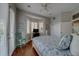 Bedroom with bay window, hardwood flooring, and bright blue patterned bedding at 620 Bayway Blvd # 1, Clearwater, FL 33767