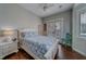 Bright bedroom with a queen bed, ensuite doors to patio, and light walls at 620 Bayway Blvd # 1, Clearwater, FL 33767