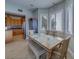 Sunny dining area with a large table, bench seating, and views to the kitchen at 620 Bayway Blvd # 1, Clearwater, FL 33767