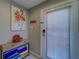Hallway with a storage table and flamingo decor by the backdoor to the outside at 620 Bayway Blvd # 1, Clearwater, FL 33767