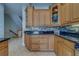 Close-up of the kitchen with custom wood cabinets, modern tile backsplash, granite counters, and stainless steel appliances at 620 Bayway Blvd # 1, Clearwater, FL 33767