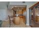 Open concept kitchen with granite breakfast bar, stainless steel appliances, and custom wood cabinets at 620 Bayway Blvd # 1, Clearwater, FL 33767