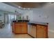 Beautiful kitchen offers wood cabinets, stainless steel appliances, and a breakfast bar that overlooks the living area at 620 Bayway Blvd # 1, Clearwater, FL 33767
