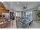 Spacious living room with stylish furnishings, ceiling fan, tile floors, and access to the waterfront balcony at 620 Bayway Blvd # 1, Clearwater, FL 33767