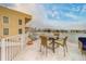 Outdoor patio features a table with seating, a beautiful view, and a white railing at 620 Bayway Blvd # 1, Clearwater, FL 33767