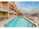 Community pool with waterfront views and comfortable lounge chairs for relaxation at 620 Bayway Blvd # 1, Clearwater, FL 33767