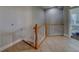 Neutral-toned hallway with light wood staircase and white railing leading to upper level at 620 Bayway Blvd # 1, Clearwater, FL 33767