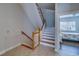Staircase leading to the second floor, with hardwood steps and white railings at 620 Bayway Blvd # 1, Clearwater, FL 33767